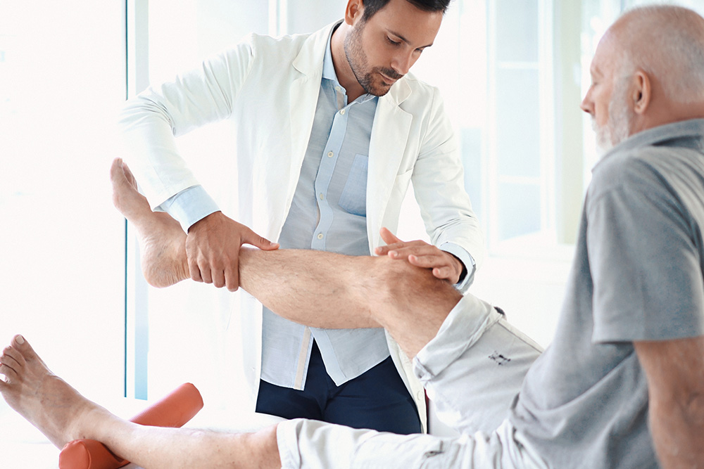 Worker fallen down while carrying cardboard boxes